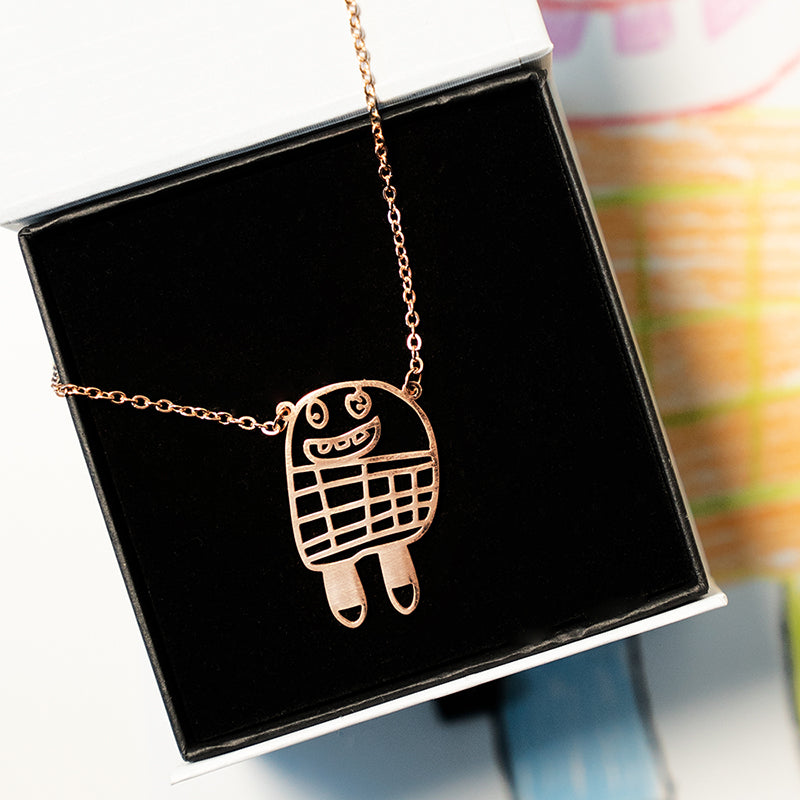 Close-up of rose gold necklace with engraved custom drawing – Drawnis jewelry gift